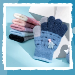 Detail of warm knitted gloves with star pattern showing soft texture and color stack