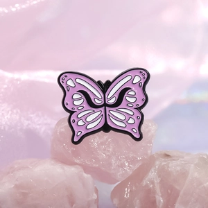 Pink and lilac butterfly enamel pin brooch on crystal stone with soft dreamy background