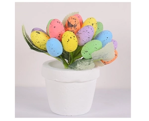 Detailed view of colorful speckled Easter egg potted plant with faux greenery in a white ceramic pot