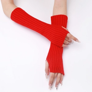 Detail view of red knitted fingerless long gloves with ribbed texture and thumb hole