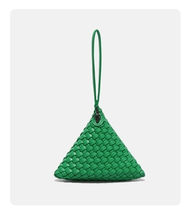Macro detail of high-saturation green woven leather texture on a triangle handbag