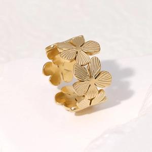 Detail of 18K gold-plated floral ring featuring a layered five-petal flower design