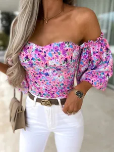 Detail of floral off-shoulder corset top with puff sleeves and elastic cuffs
