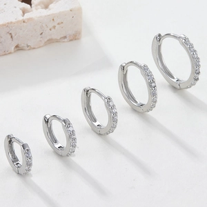 Detailed view of 925 sterling silver hoop earrings with cubic zirconia in five various sizes