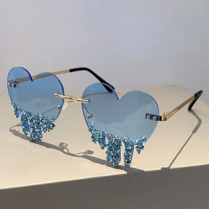 Detail view of heart-shaped rimless sunglasses with blue rhinestone waterdrop tassels