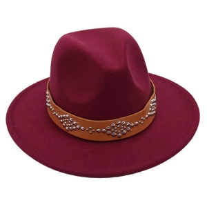 Detail of burgundy wool fedora hat featuring brown leather band with silver metal studs