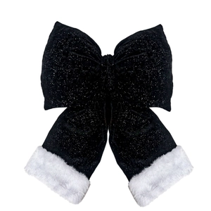 Detail of glittery velvet Christmas bow with soft white faux fur trim and sparkling texture