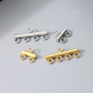 Detail view of gold and silver multi-hole stainless steel jewelry connectors with ring loops
