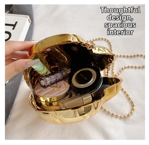 Interior view of gold shell evening bag holding lipstick and makeup accessories