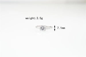 Detail view of silver titanium steel ring featuring 7.1mm round moissanite and weight info