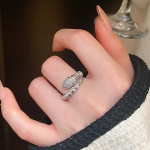 Detailed close-up of snake-shaped silver ring with shimmering zircon-paved scales