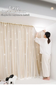Close-up of beige double-layer blackout curtain with lace trim and star LED lights