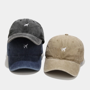 Vintage washed cotton baseball caps with airplane embroidery in black, navy, and khaki