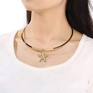 Detailed close-up of a gold starfish pendant necklace on a model with metallic luster
