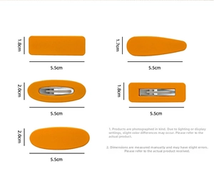 Close-up of matte orange geometric hair clips with metal alligator clips and measurements