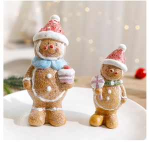 Detail of Christmas resin gingerbread man figurines with festive frosted texture and hats