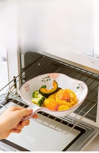 Ceramic bowl heat-resistant material being placed into an oven for baking