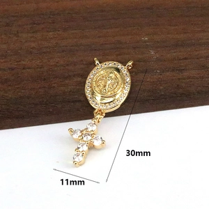 Close-up of gold religious pendant with Virgin Mary medal and zircon cross, 30mm height