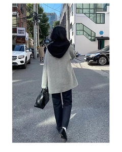Rear view of a grey hooded wool coat with stylish drape and urban street style silhouette