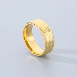 Detailed view of wide gold titanium ring with hammered texture and polished inner band