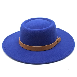 Detail of wool felt boater hat with brown leather band and gold metal rivet accents