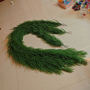 Close-up of flexible green PE artificial pine garland for Christmas mantel decoration