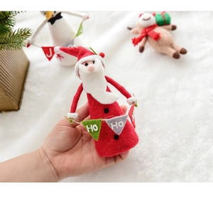 Detail of wool felt Santa Claus ornament holding Ho Ho flags for Christmas tree decor