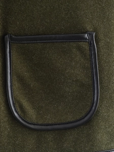 Detail of olive wool coat pocket with black PU leather trim and neat stitching