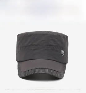 Close-up of dark gray cadet cap featuring breathable mesh sides and metal shield emblem