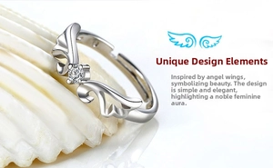 Macro shot of silver angel wing ring with a sparkling crystal on a white shell