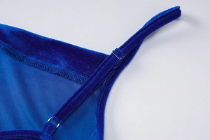Close-up of adjustable strap on blue velvet dress with high-quality metal hardware detail