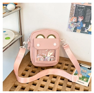 Detail of pink canvas ita bag with transparent PVC window for badge display and strap