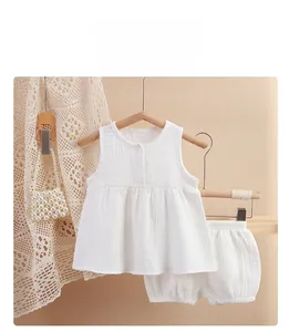 Detailed view of white double-layer cotton gauze baby set with sleeveless top and bloomers