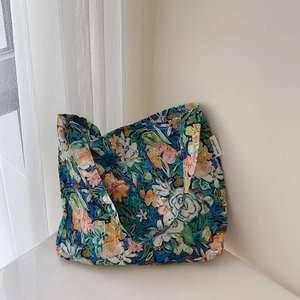 Detail of floral canvas tote bag with simple wish label and soft cotton pleats
