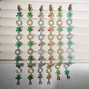 Detailed display of six zircon flower bracelets in various colors on a velvet tray