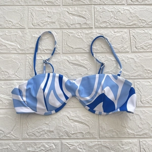 Detail of blue and white wave print bikini top with underwire and adjustable straps