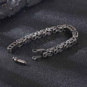 Macro detail of antique silver Byzantine chain bracelet with screw shackle closure