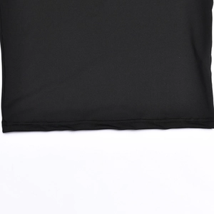 Detailed macro view of the black fabric texture and neat stitching on the dress hemline
