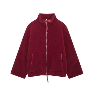 Close-up of wine red sherpa fleece jacket featuring zipper closure and large patch pockets
