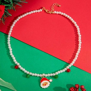 Close-up of Christmas necklace featuring white pearls and a cute Santa Claus pendant