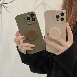 Detail view of olive green and beige matte phone cases with matching round sockets