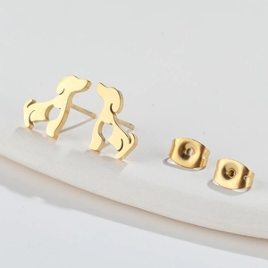 Macro shot of gold stainless steel dachshund dog stud earrings on a white display stand