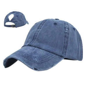 Distressed blue denim ponytail baseball cap with ripped edges and vintage wash