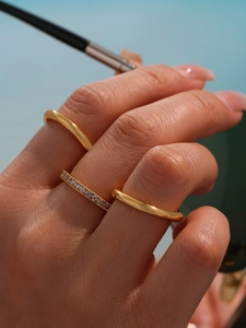 Macro view of gold-plated triple-layered ring set with sparkling 5A cubic zirconia stones