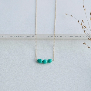 Minimalist 14K gold plated necklace featuring three oval turquoise stones on a fine chain
