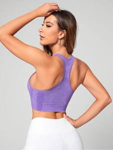 Close-up of racerback design on purple sports bra with breathable mesh detail