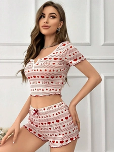 Detail of red heart and LOVE print on white rib knit pajamas with lace trim