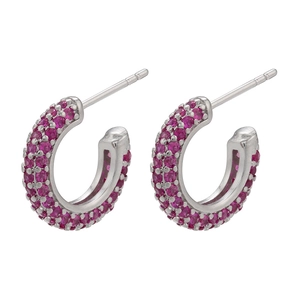 Detailed view of silver C-shaped earrings with micro-paved magenta cubic zirconia stones