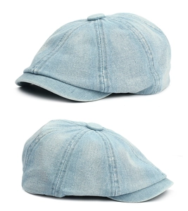 Detail of light blue denim newsboy cap with vintage washed texture and classic top button