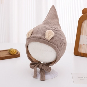 Detail of baby winter pointed knit hat with ears and secure chin ties in brown